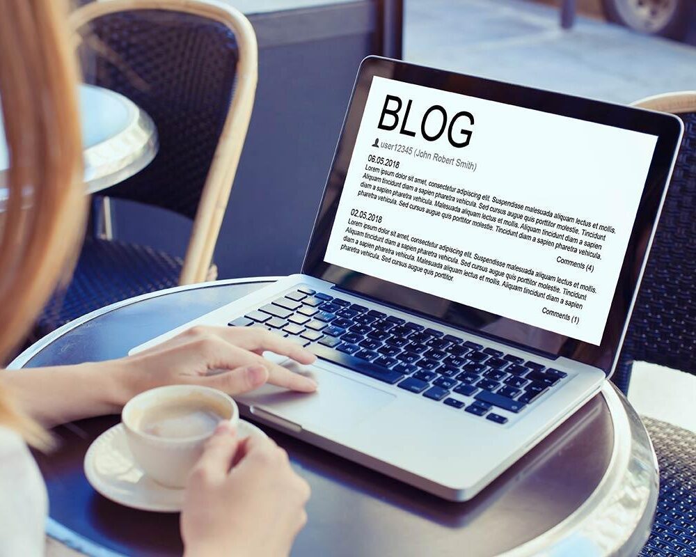 woman writing a blog to help with her marketing