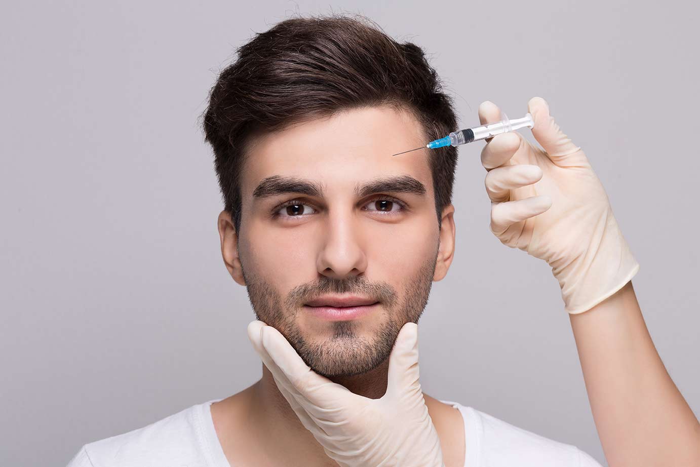 Man having botox injected into forehead